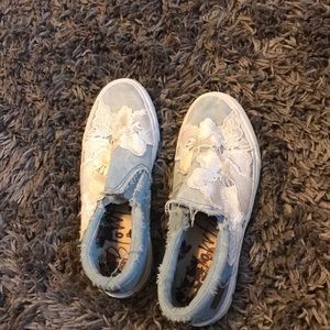 blue slip on shoes with lace flowers.